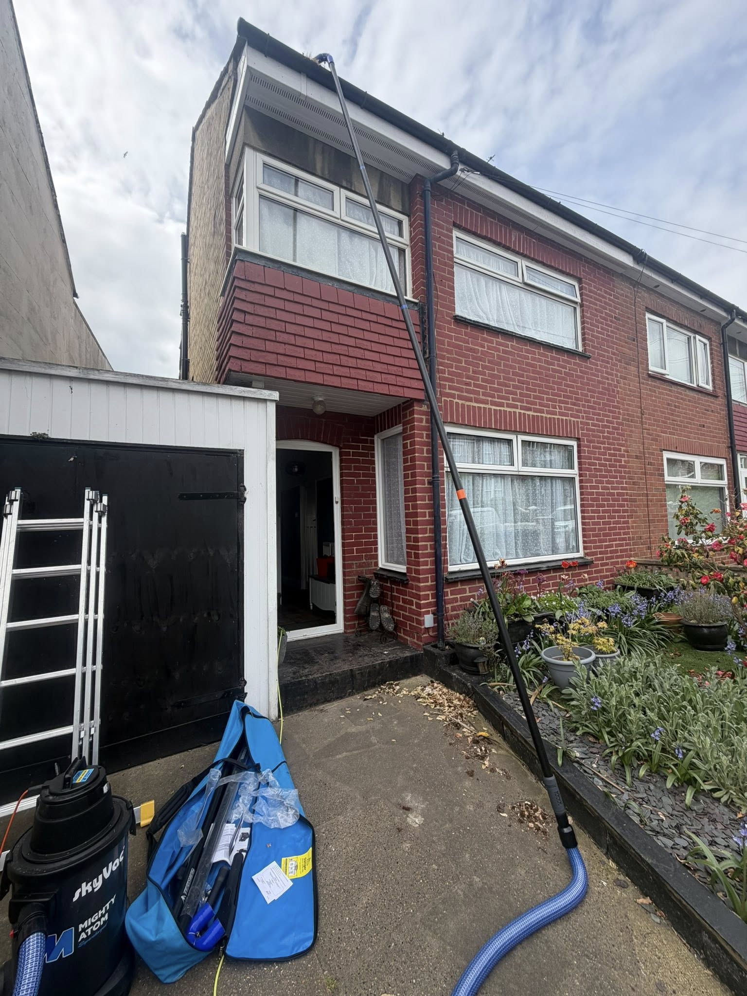 Exterior cleaning in progress on residential brick property
