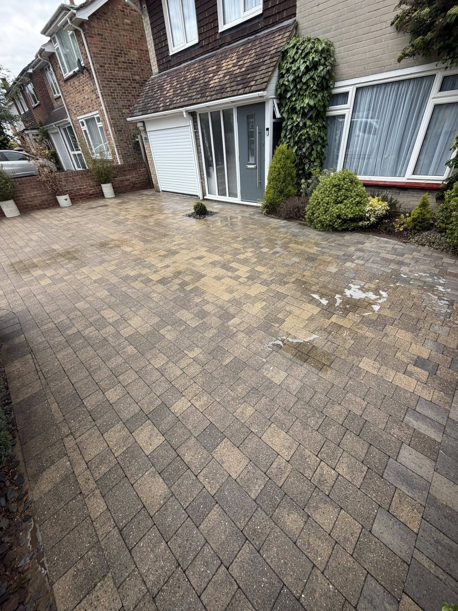 Clean driveway with herringbone paved surface after cleaning